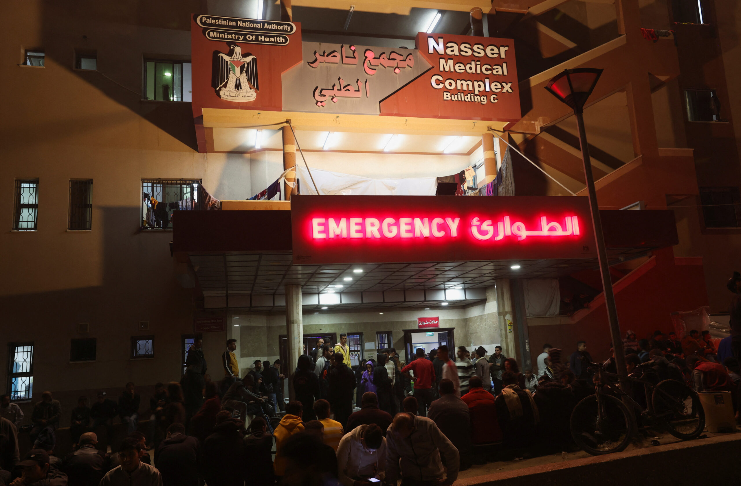 Families search for loved ones among hundreds of bodies exhumed from mass grave in Nasser Hospital